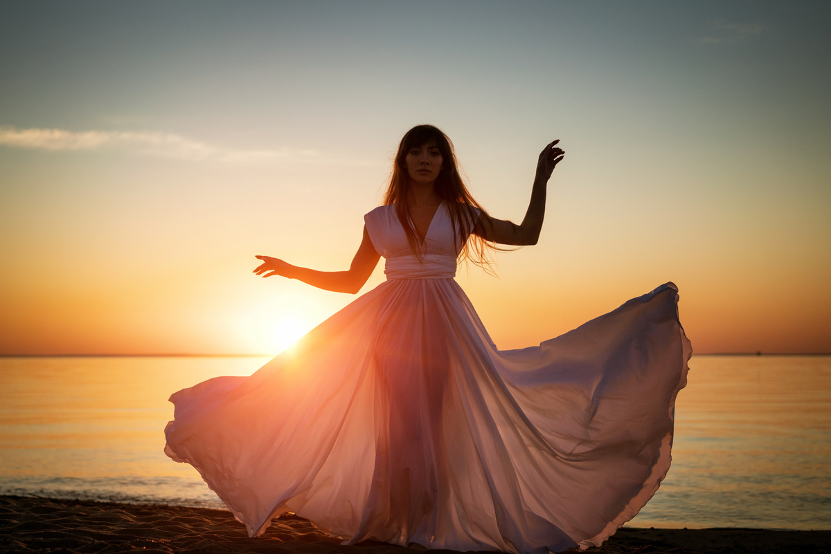 Woman Wearing Dress at the Beach During Sunset